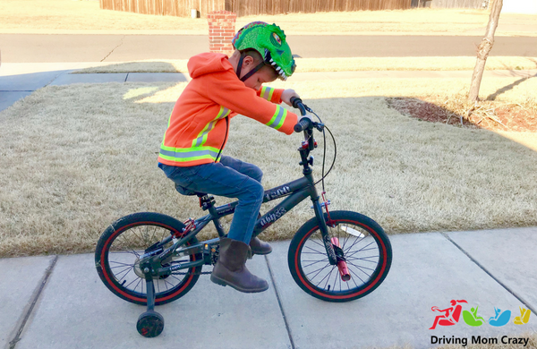 child riding bike with hoodie on