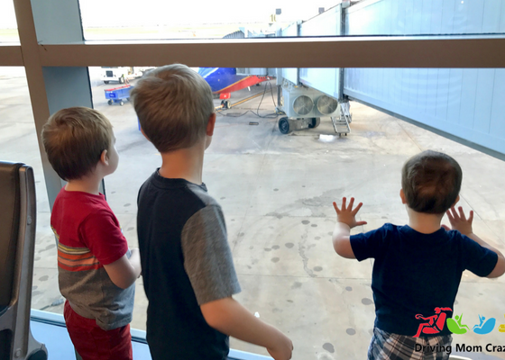 kids watching planes at the airport