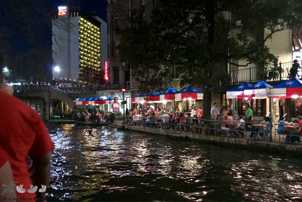 Outdoor restaurant seating at night on the San Antonio Riverwalk