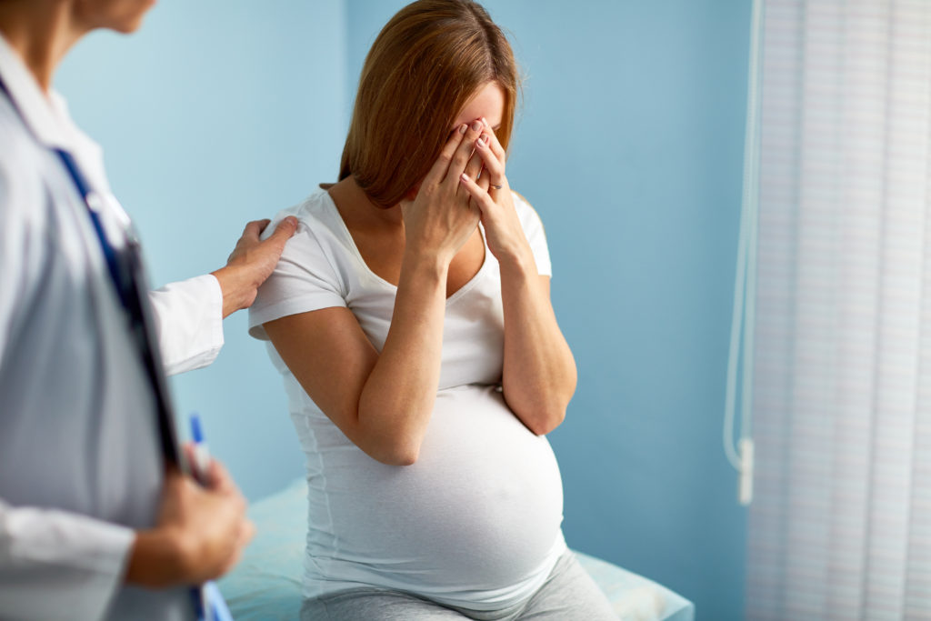 pregnant mother talking to OB/gyn about depression and mental health