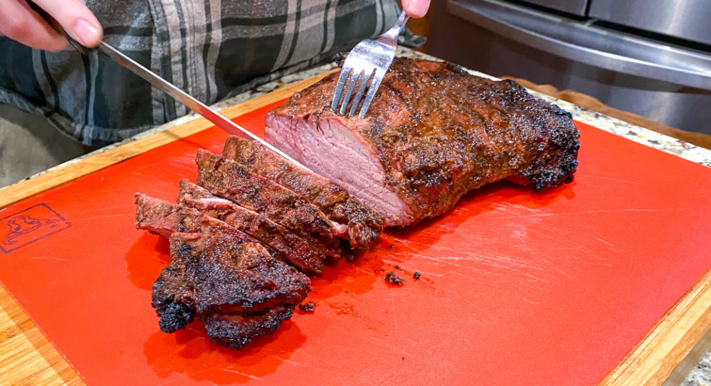 smoked tri-tip being sliced